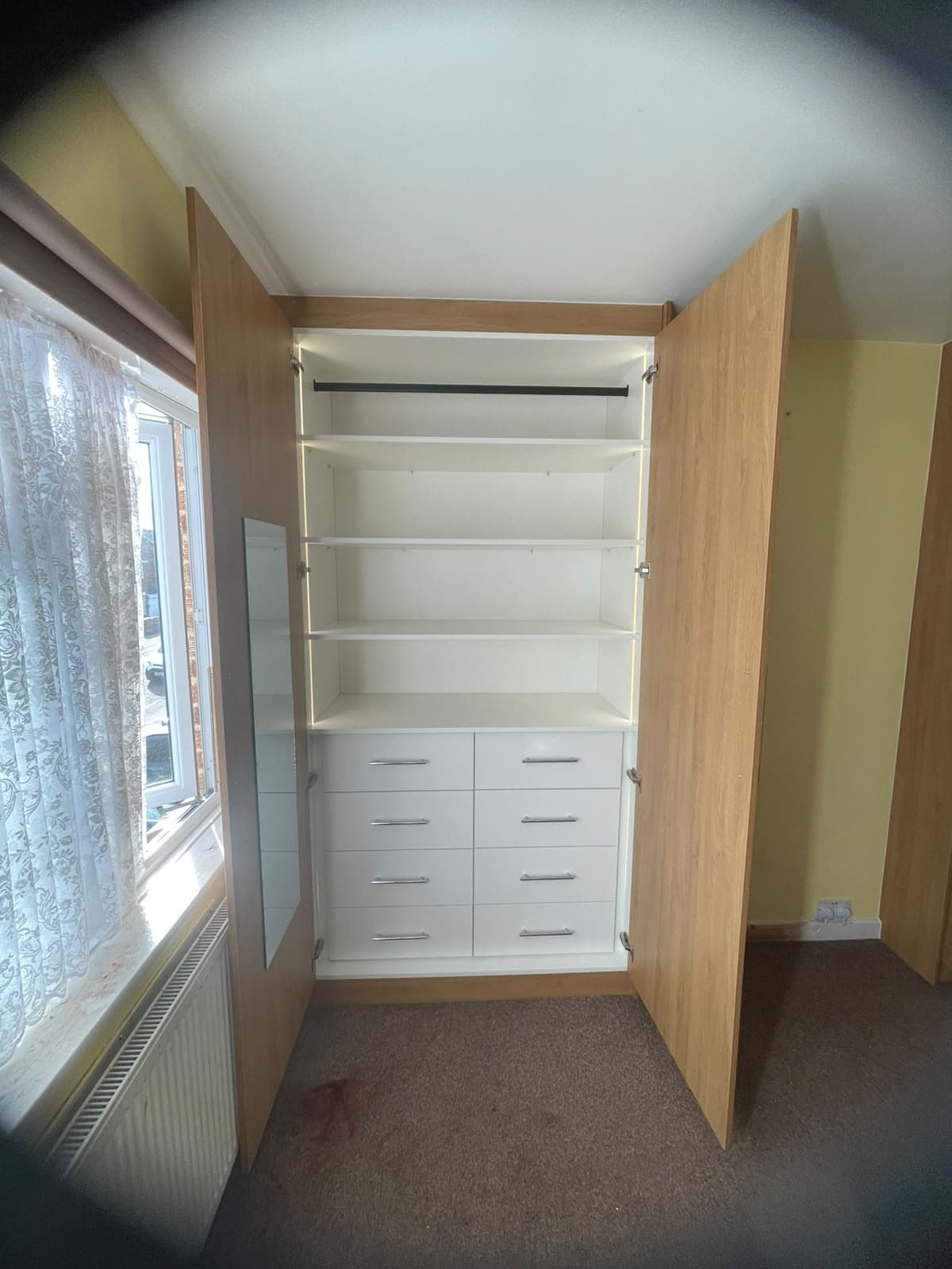 Close-up of wardrobe interior shelving section and drawer chest from the side